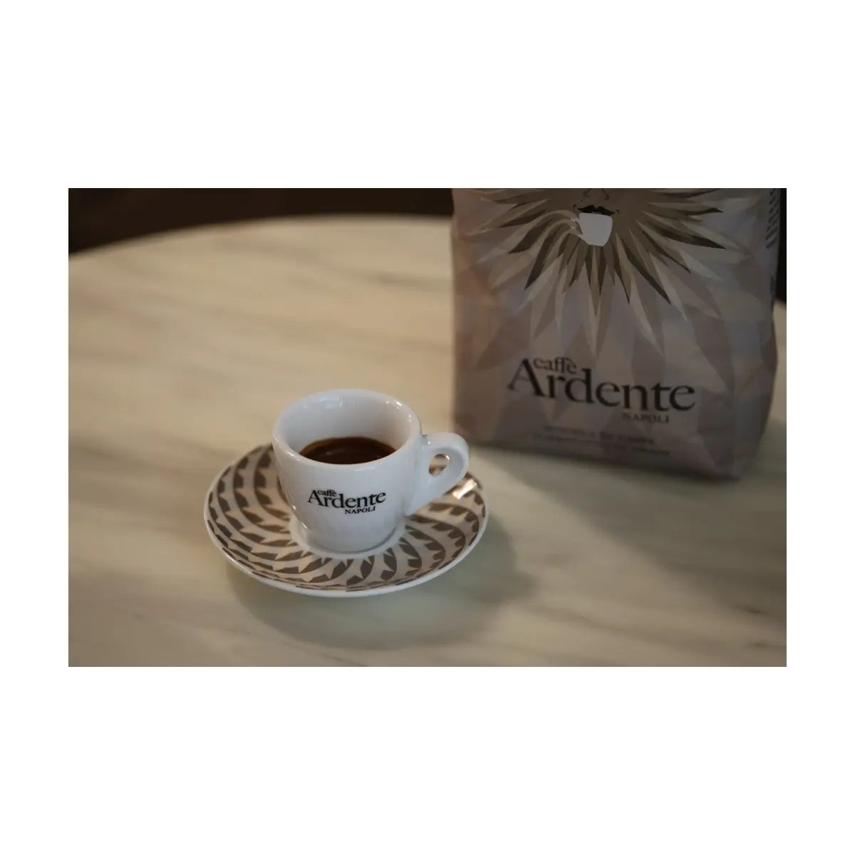 Ardente Espresso Tasse mit Kaffee gefüllt auf einem Tisch vor einer Packung Kaffee